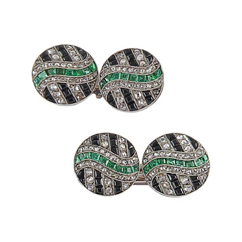 Pair of Art Deco diamond, onyx and emerald cufflinks, c.1925, possibly French, circular panels with a geometric design,